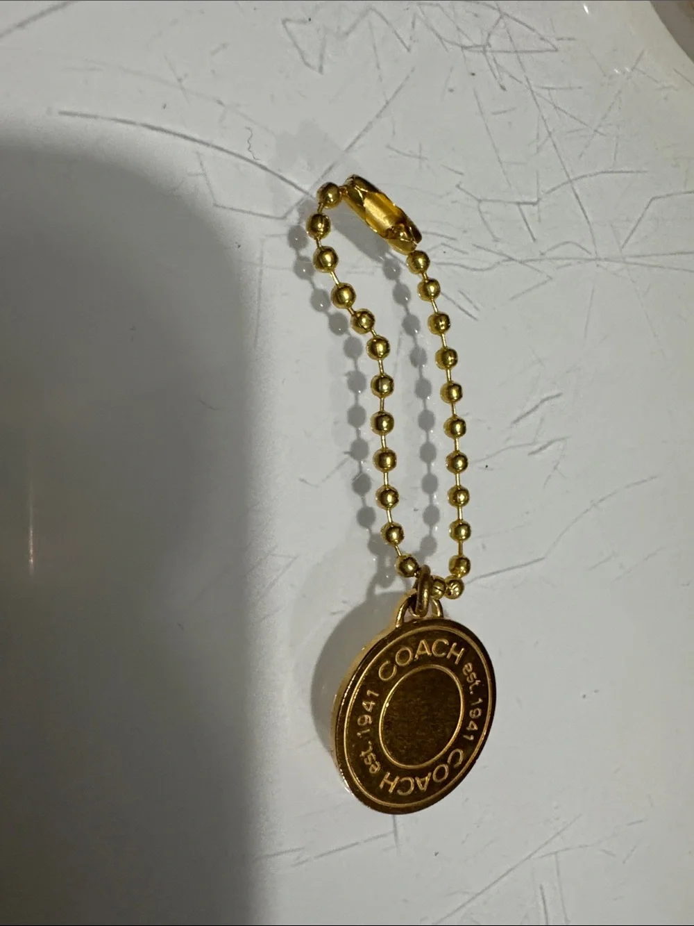 Coach gold tone